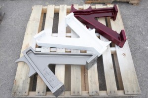 Stages of Liquid Penetrant Inspection (Red Dye, White Developer, Gray Finished Casting)